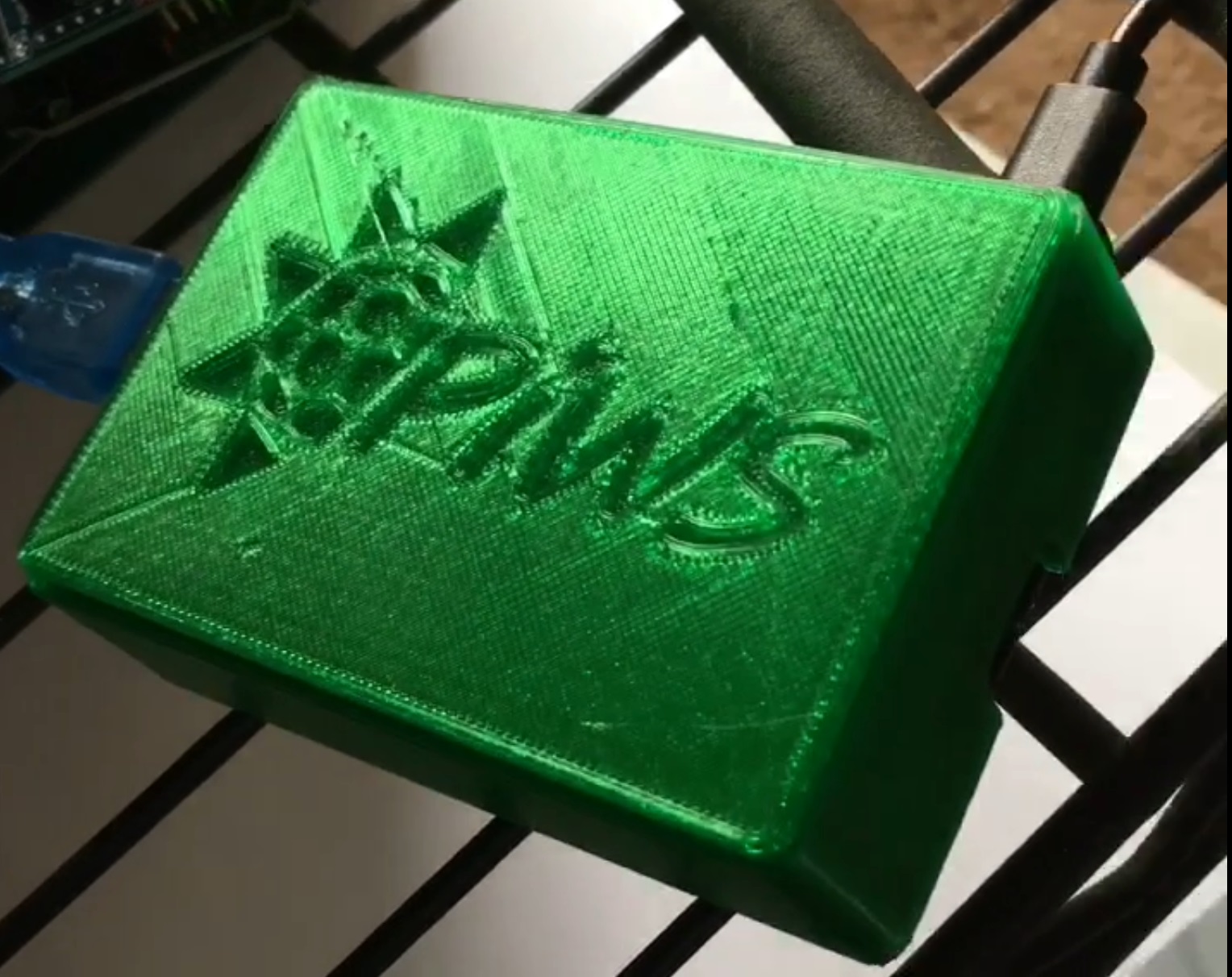 Picture of an early version of the 3D printed PiWS enclosure, translucent green in color.