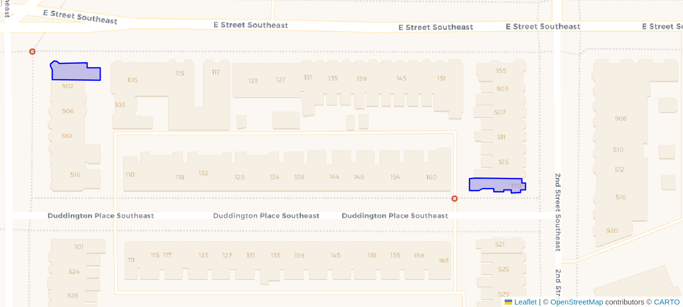 View of a block of buildings in OpenStreetMap with two buildings highlighted in blue and nearby endpoints for routing shown as red dots.